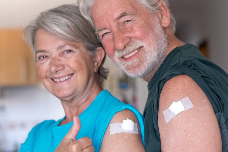 couple 70 years old smiling after receiving the booster of the coronavirus covid-19 vaccine. Concept of prevention and immunization