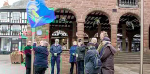 Commonwealth spirits un-dampened by weather during flag raising
