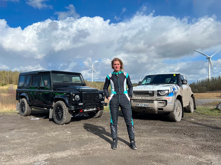 Vanessa Ruck in front of two Defender 110s