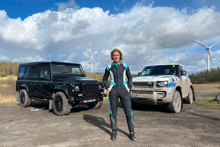 Vanessa Ruck in front of two Defender 110s