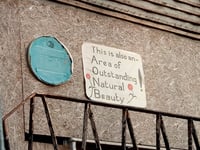 Sign of the times: blue plaque’s new neighbour