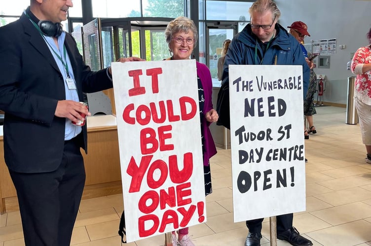 Supporters of the Tudor Centre who attended the scrutiny committee meeting with posters.