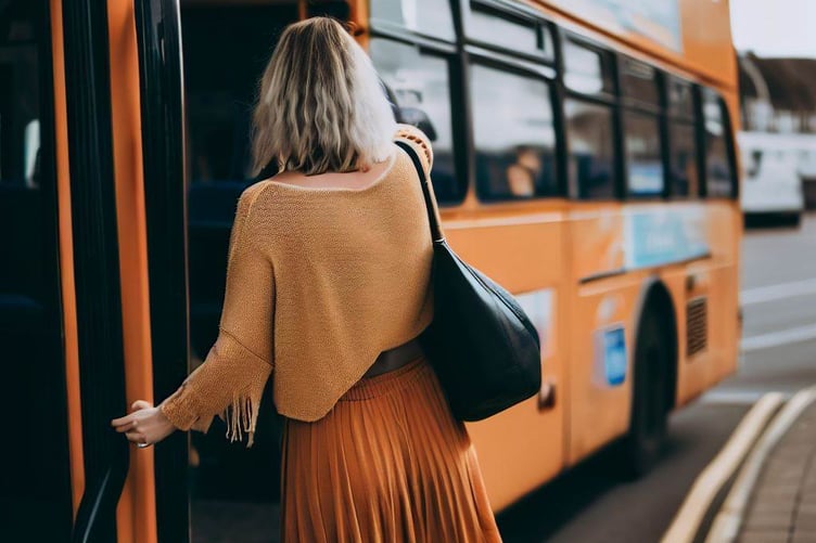Woman getting on bus