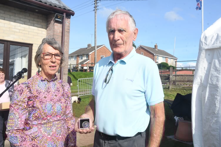 Show president Diana Standing presents the Banksian Medal to John Baker. *** Local Caption *** Show president Diana Standing presents the Banksian Medal to John Baker.