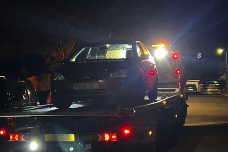 Seized car being towed away in Caldicot