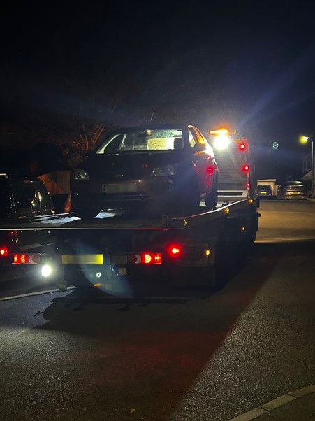 Seized car being towed away in Caldicot
