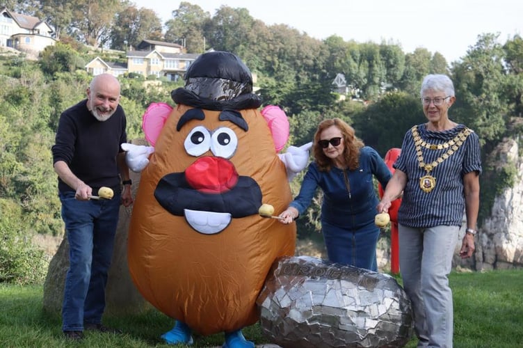 Potato and spoon race: Mr Potato Head was welcomed by Mayor of Chepstow Cllr Margaret Griffiths (right) and members of the Chepstow Spudfest organising committee, Cllrs Jim MacTaggert and Vanessa Badderley-Potter, at the Pebble sculpture at the start and finish of the Wales Coast Path, Chepstow.