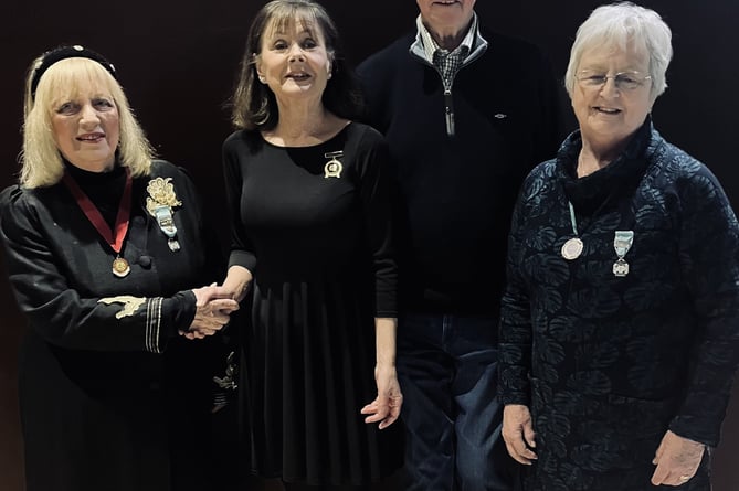 Helen Stidolph is presented with a Commendation Medal for dedicated service to musical theatre by Dee McIlroy, NODA Wales & Ireland Regional Representative, watched by president Diane Sillman and chairman Stephen Brettle
