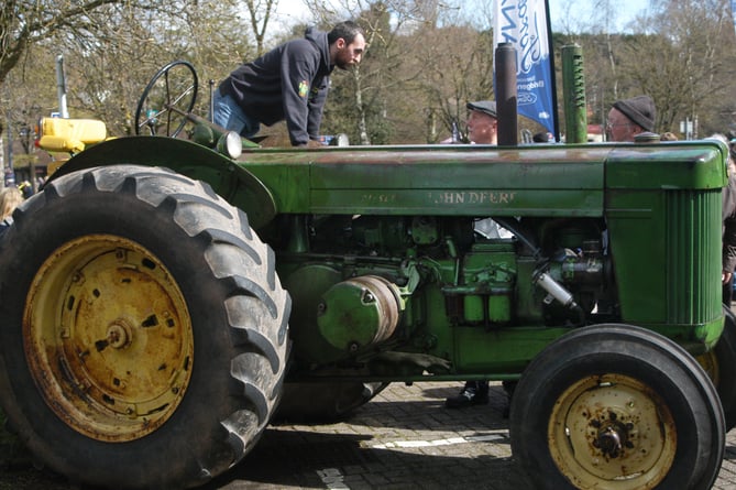 Daniel Morris from Coleford speaks with visitors about his John Deere R tractor from 1951.