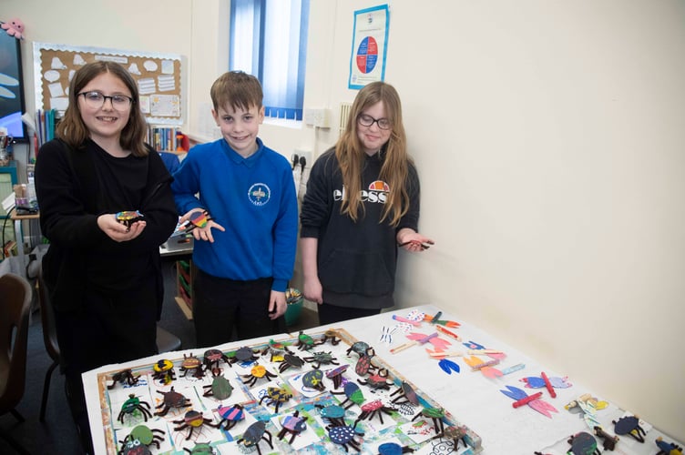Children with some of the dozens of 3D bugs that were made.