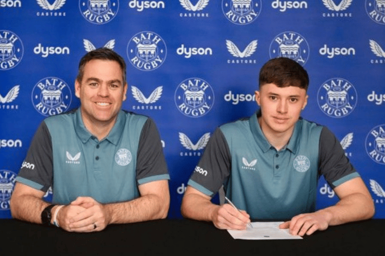 Monmouth School's Jack Woods signs for Bath Rugby Academy watched by head of rugby Johann van Graan. 