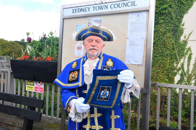 Lydney town crier Tim Embon reads the proclamation of the first anniversary of the coronation of His Majesty the King.
