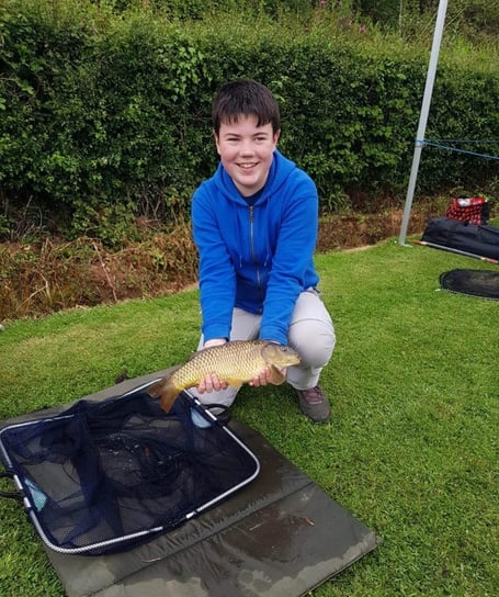 A happy angler with a common carp