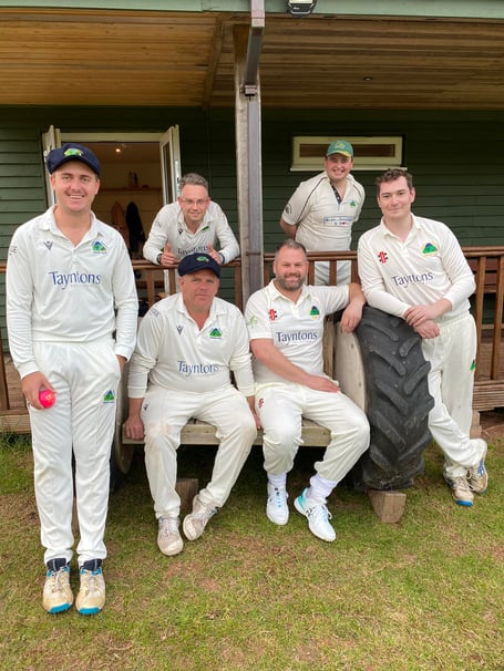 A sign of summer – Aston Ingham players relax at their ground on the Ben Savidge homemade bench