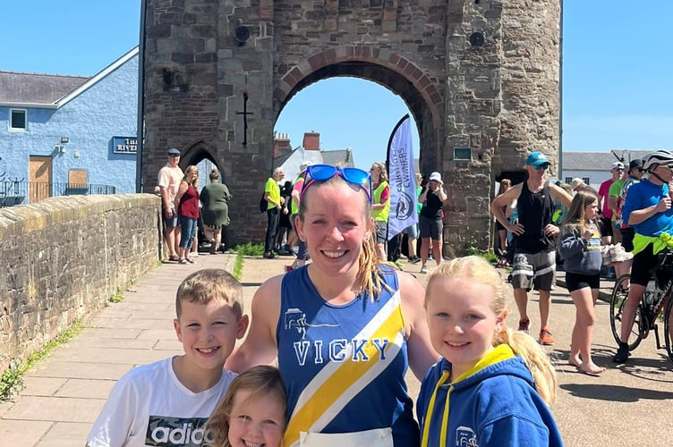 Vicky Roberts with her children after finishing her leg at Monnow Bridge