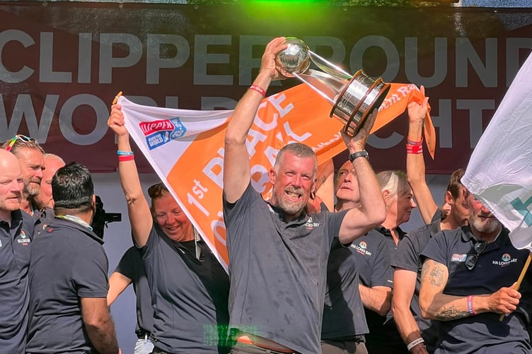 Eric Froggatt lifts the Clipper Round the World trophy