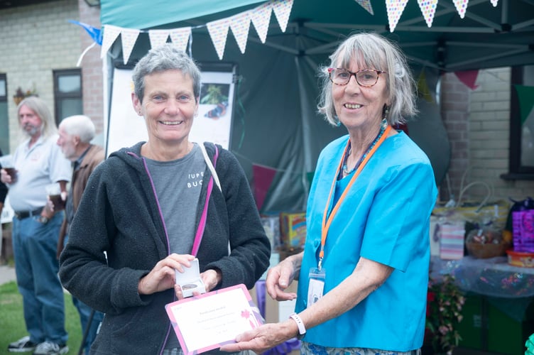 Sue Hill is presented with the Royal Horticultural Society Banksian Medal by show president Diana Standing.