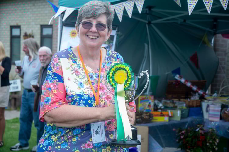 Trudi Breadman with the Len Preest Trophy for a collection of vegetables., one of nine trophies she won.