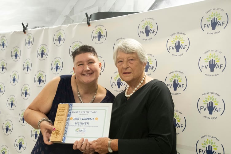 Emily Worrall (left) is presented with the Volunteer of the Year Award by Dame Janet Trotter.