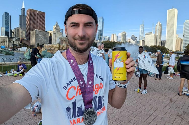 Martin Turner celebrates after running the Chicago Marathon