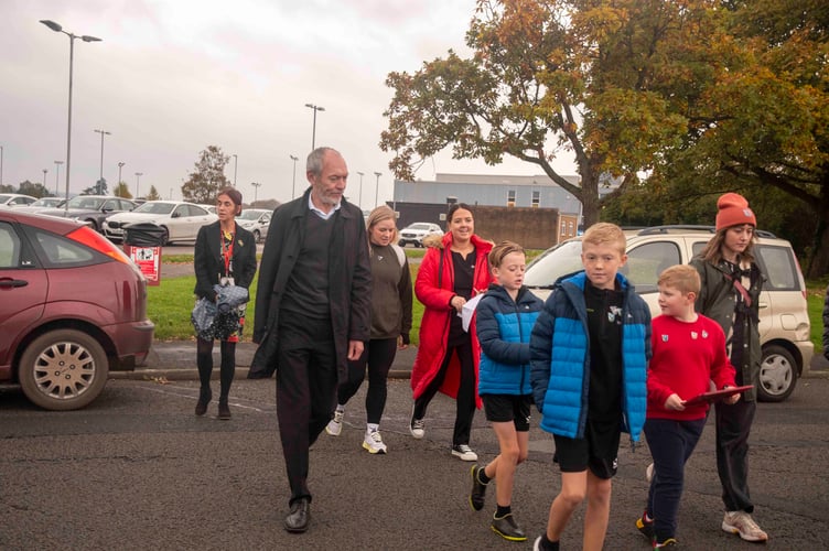 John Griffiths and children cross Mill Lane