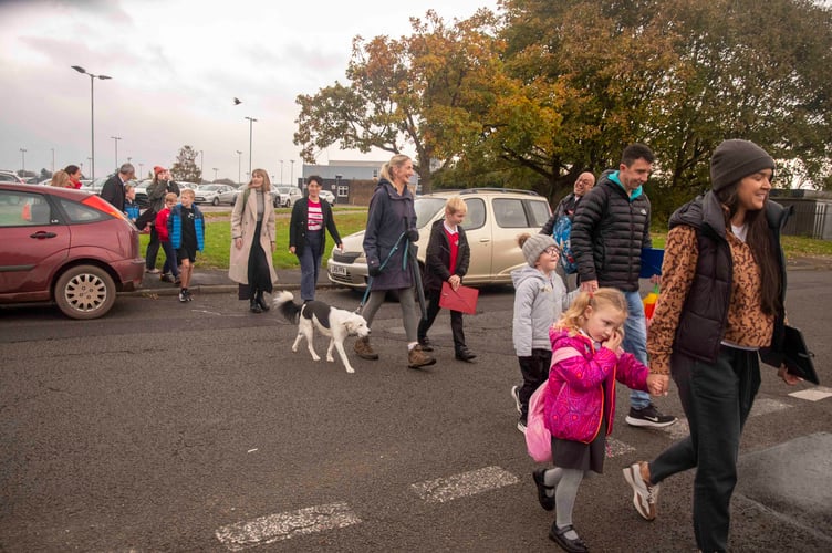 Traffic is stopped to allow the walkers to cross Mill Lane.