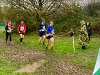 Runners brave the weather to storm home