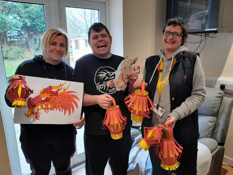 Photo caption: Service user Rhys and his support workers with the artwork created to celebrate Chinese New Year.