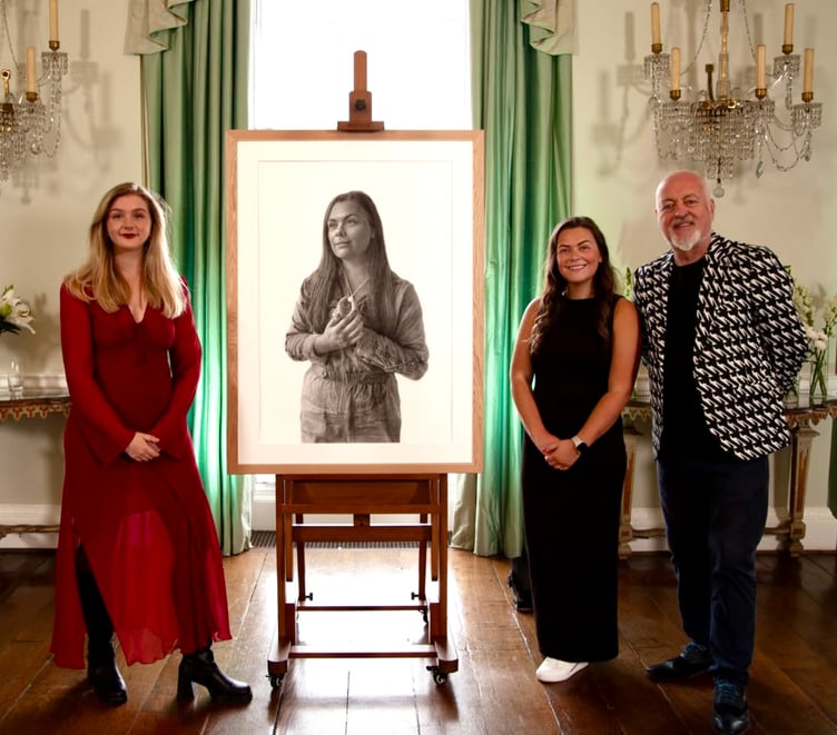 Oriane, left, with her portrait, Clare and Bill Bailey