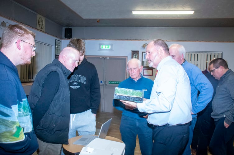 Pete Bell shows a sample of the new surface to some of the people at the launch event.
