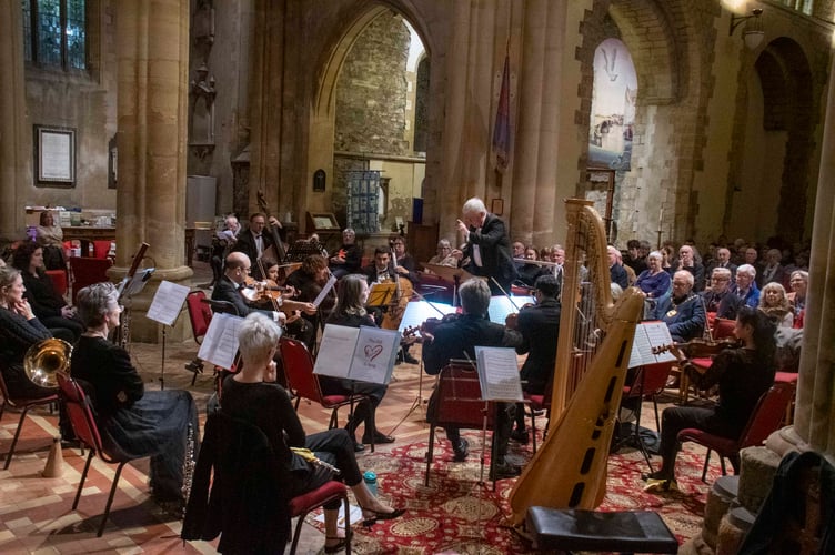 Graham Bull conducting the choir and orchestra.