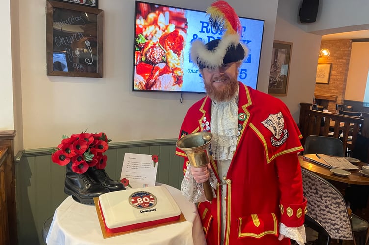 Cinderford Town Crier Jer Holland with a celebration cake at the Golden Lion pub in High Street.