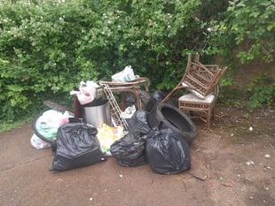Black bags, furniture, a tyre and bike parts dumped near donation bin