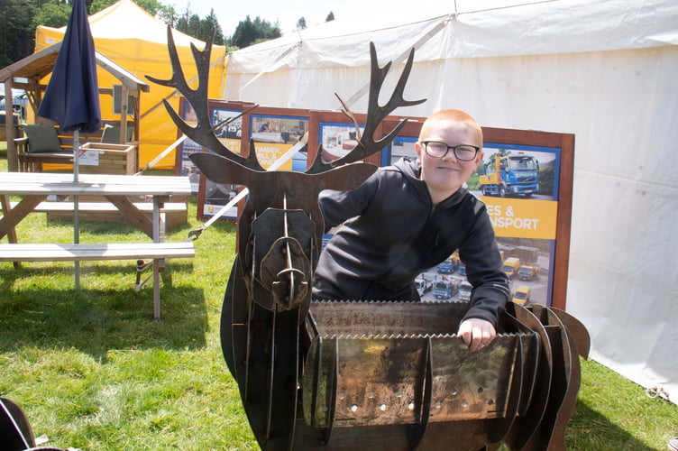 Jack Brain with a deer-inspired barbecue made by dad Gareth which was raffled to raise money for cancer research