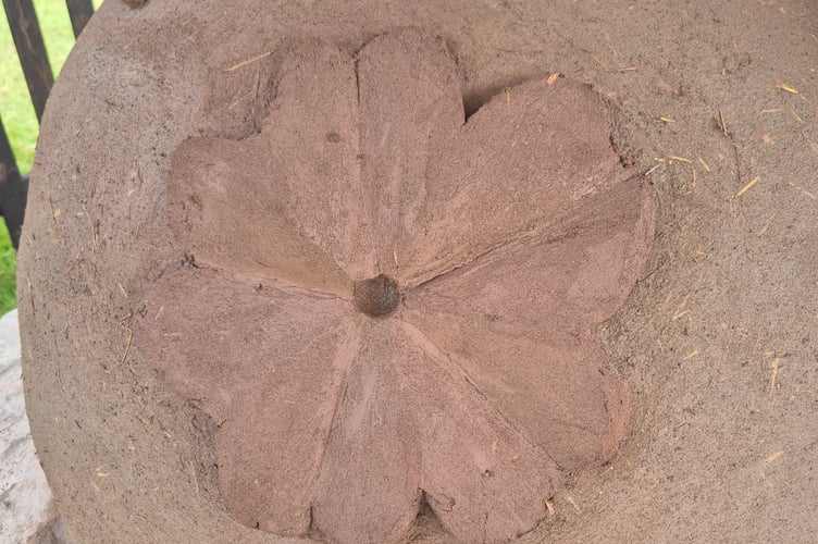 The primrose emblem on the oven.