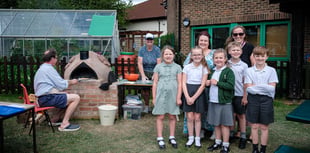 Kids enjoy pizza from oven they built