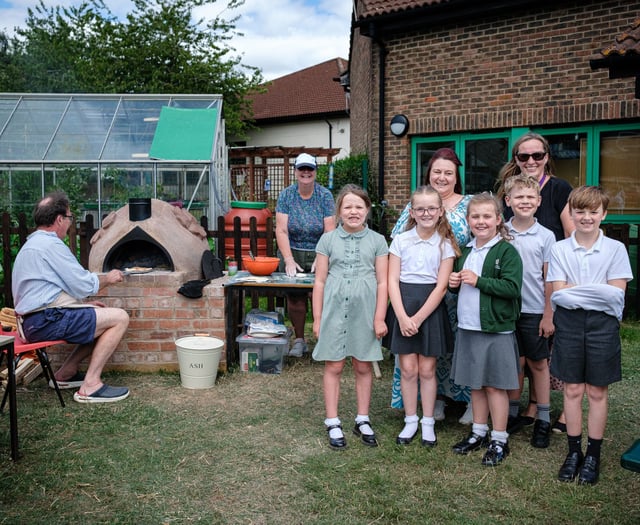 Kids enjoy pizza from oven they built