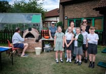 Kids enjoy pizza from oven they built