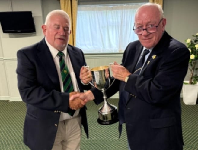 The photo shows Derek Workman F.o.D. Captain receiving the trophy from Jon Mills of Lydney.