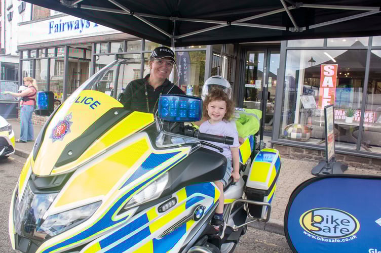 Four-year-old Alva Cullis on the police bike with PC Shelley Holloway.