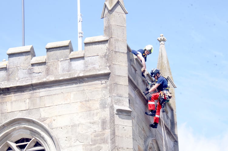 Firefighters demonstrate a rope rescue on Coleford clocktower.