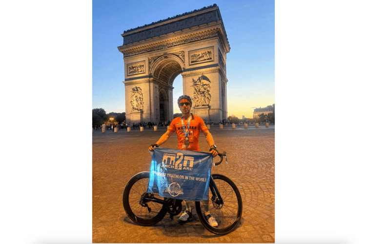 Sam Weale in front of the Arc de Triomphe after completing his epic challenge. Photo: Sam Weale