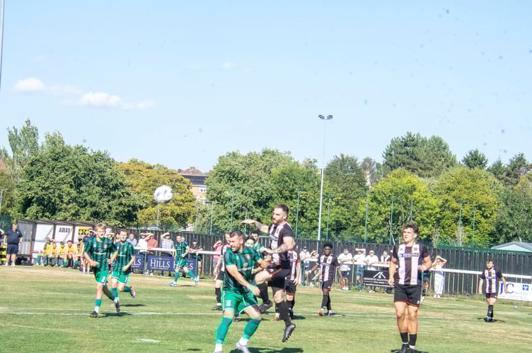 Lydney's Craig Baldwin gets up high.