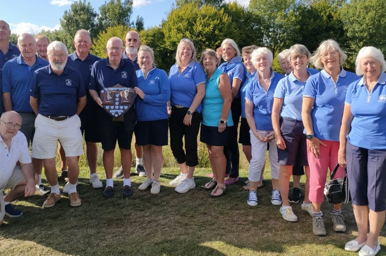 Clive Winward and Amanda Jones, with the resurrected Seniors v Ladies Trophy, flanked by their teams