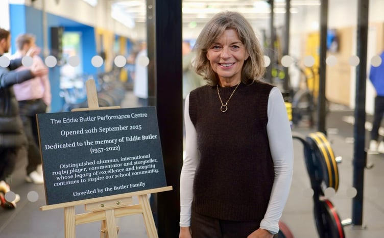 Sue Butler stands beside the plaque dedicated to her husband Eddie at the official opening of the sports centre of excellence named after him at Haberdashers' Monmouth