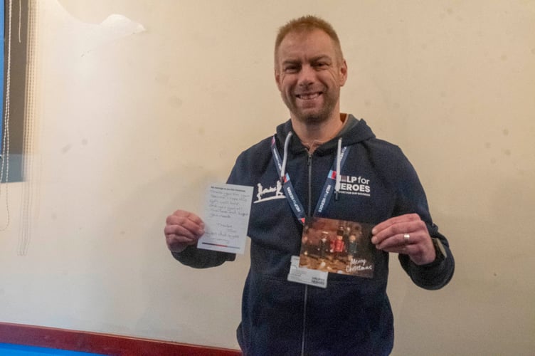 Ash Winter of Help for Heroes with a handwritten card from a supporter of the charity for a veteran.