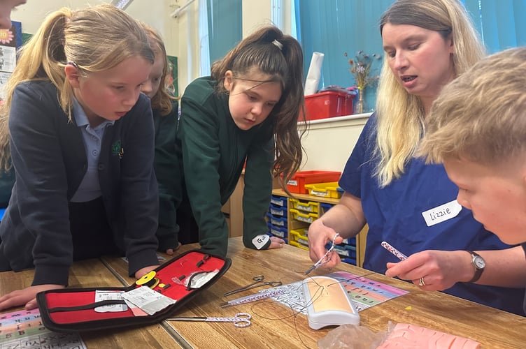 Vet Lizzie Youens demonstrates sewing techniques.