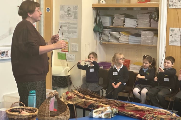 Pupils have a go at basket weaving with Hannah Beasley.