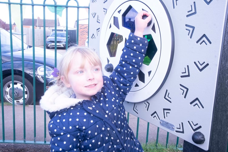 One of the younger children tries out a sensory panel.