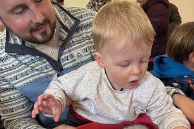 Father and son Adam and Sebbie with the guinea pigs.